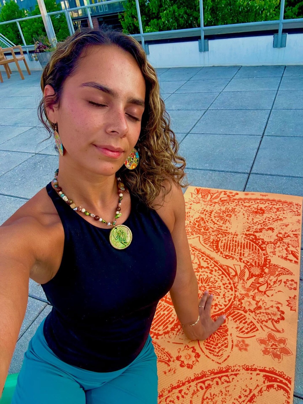 Priscila in meditation, eyes closed, golden light